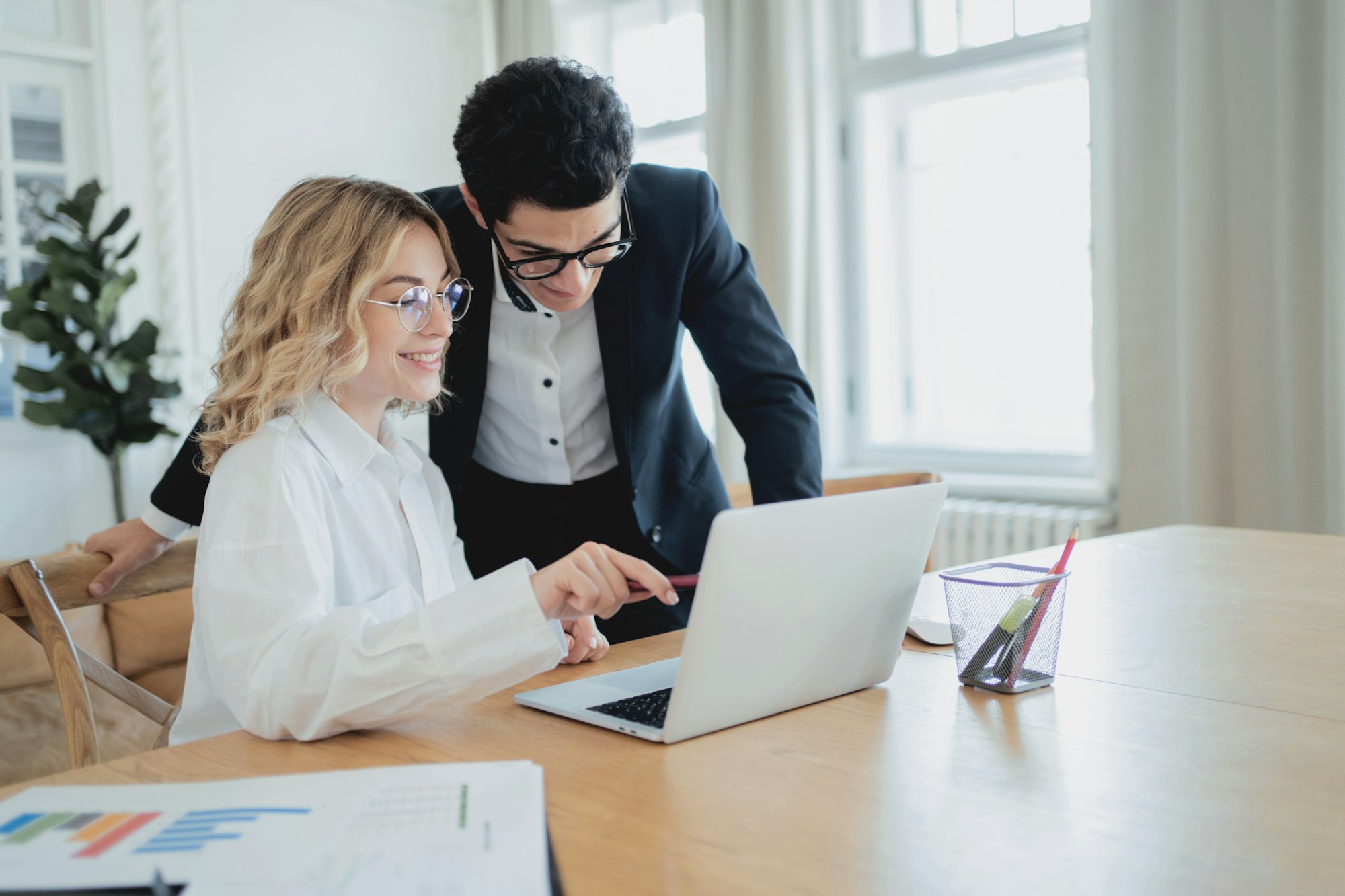 A copywriter is a woman and a designer is a man communicating in the workplace.